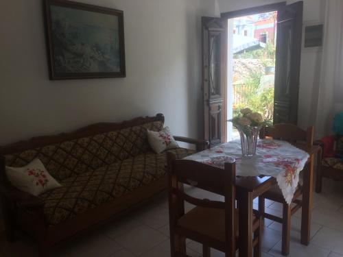 a living room with a table and a couch at Nikos and Eva Studios in Symi