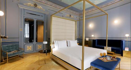 a bedroom with a white bed and a blue wall at Axel Hotel Madrid - Adults Only in Madrid