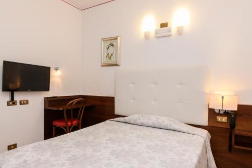 a bedroom with a bed and a flat screen tv at Hotel San Marco in Montebelluna