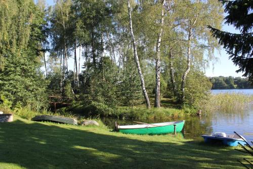 a green boat on the shore of a lake at Prie Klykio in Utena
