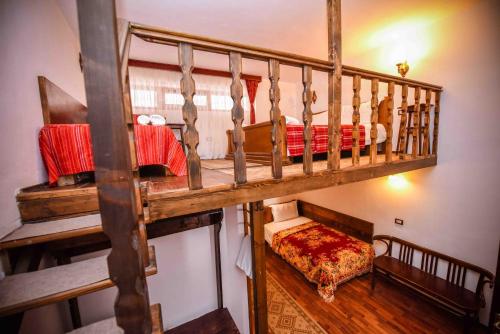 a room with two bunk beds and a couch at Hotel Tradita in Shkodër