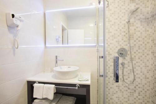 a bathroom with a sink and a shower at Boutique Hotel Intermezzo - Pag centre in Pag