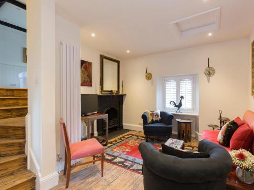 a living room filled with furniture and a fireplace at Castle Gatehouse in Winchcombe