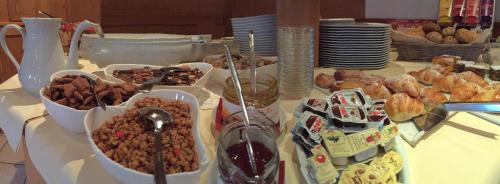 a table with many different types of food on it at Hotel Garni Schneider in Lutago
