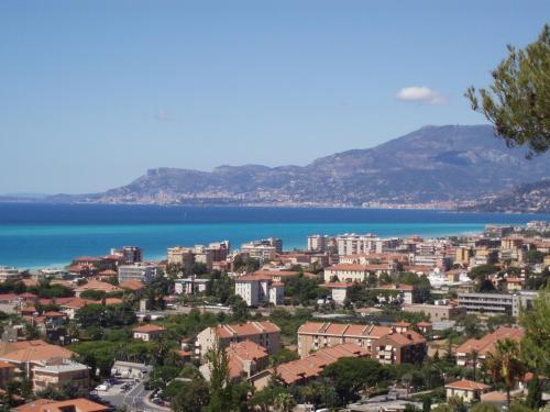 a view of a city and a body of water at Villa Gaia - Luxury Villa, pool & wellness rooms in Bordighera