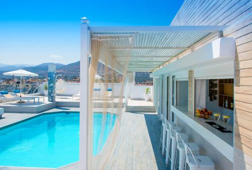 a house with a swimming pool and a patio at Senses Blue Boutique hotel in Hersonissos
