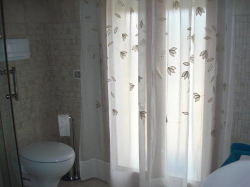 アルバタックスにあるCasa Lisa a Porto Frailisのバスルーム(トイレ、蝶が描かれたシャワーカーテン付)