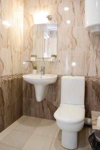 a bathroom with a toilet and a sink at Guest House Raiski Kаt in Mezek