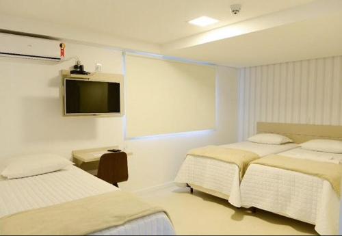 Un pat sau paturi într-o cameră la Hotel Vizzion