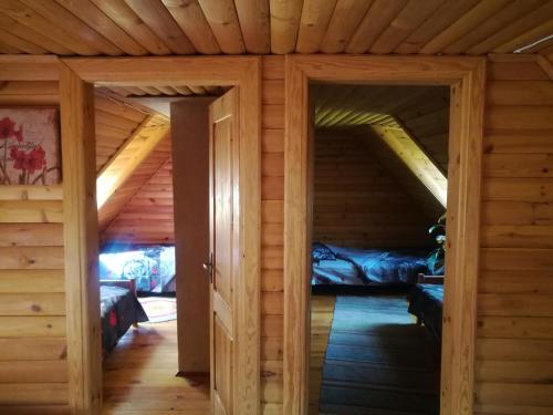 Habitación con 2 puertas en una cabaña de madera en Brīvdienu māja Strazdi, en Ugāle