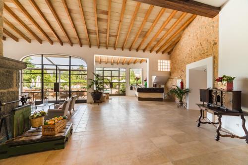 a large living room with a wooden ceiling at Hotel Ca'l Bisbe in Sóller