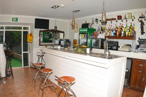 a bar with stools and a counter in a room at Hotel Rural Isasi in Gordexola