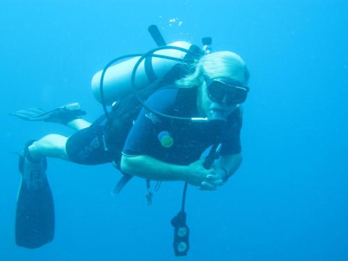 a young girl in a scuba diving gear underwater at Caribbean Chillout Apartments in Kralendijk