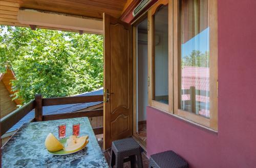 a table on the balcony of a tiny house at Hotel Forest Fairy in Shekvetili