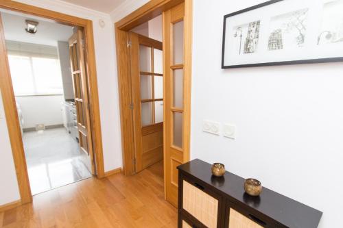 a living room with a table and a hallway at WonderStays Apartamentos La Estación in Málaga