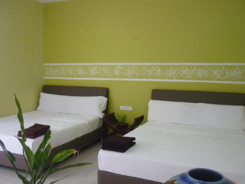 Postel nebo postele na pokoji v ubytování Hotel Paka INN