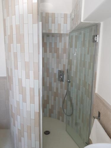 a shower with a glass door in a bathroom at Casa Gaia in Capri