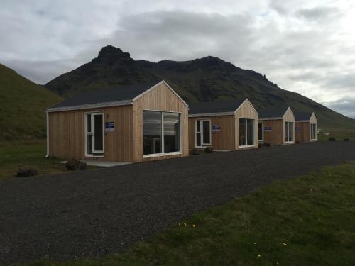 a row of modular homes in front of a mountain at Welcome Holiday Home in Eyvindarhólar