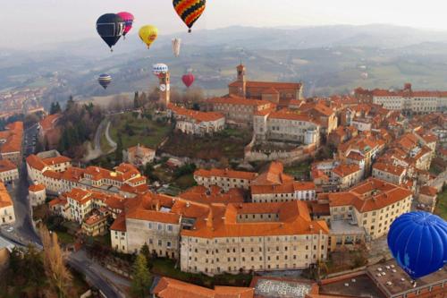 a group of hot air balloons flying over a city at Il Mulino Di Geminella in Narzole