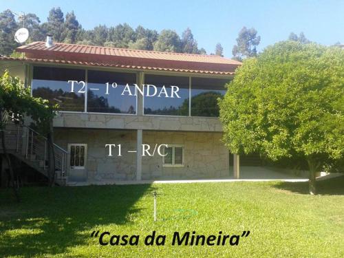 a building with a sign on the side of it at Casa da Mineira T1 in Geres