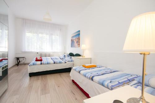 A bed or beds in a room at Andrássy Apartment with Inside Parking