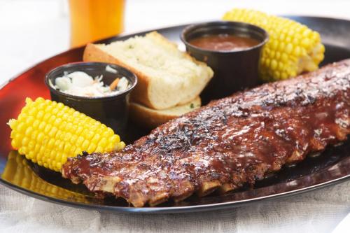 a plate with two ribs and corn on the cob at Ellis Island Hotel Casino & Brewery in Las Vegas