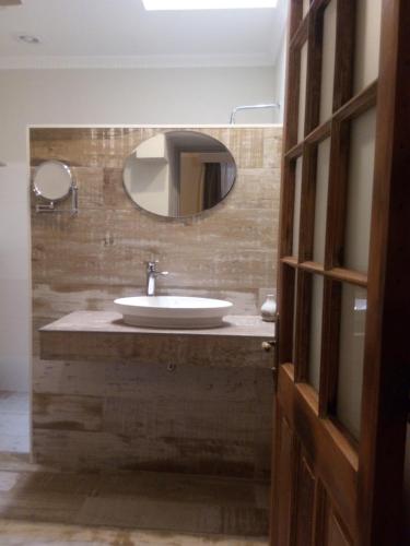 a bathroom with a sink and a mirror at Hotel Boutique BC Wine Casablanca in Casablanca