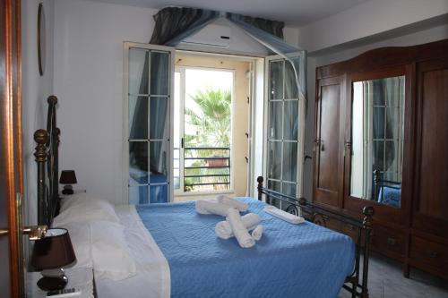 a bedroom with a bed with towels on it at Patrancarro Home - Letojanni Taormina in Letojanni