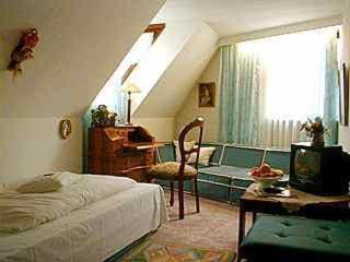 a bedroom with a bed and a desk and a couch at Resengörg in Ebermannstadt