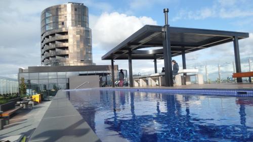 a swimming pool on the roof of a building at Whitehorse Towers Self Service Holiday Apartment in Box Hill