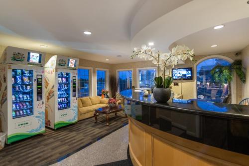 a room with two refrigerators and a bar in a store at Canadas Best Value Inn Chinook Station in Calgary