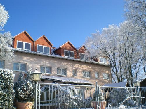 a building with a fence in front of it at Hotel-Restaurant Weinberg in Artern