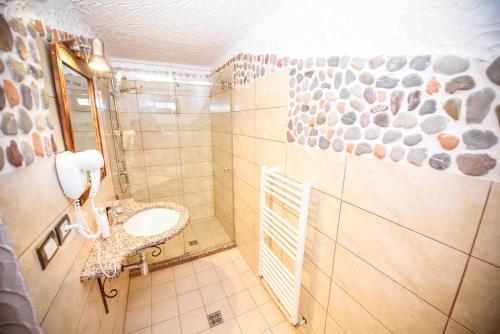 a bathroom with a sink and a toilet in it at Hotel Tradita in Shkodër