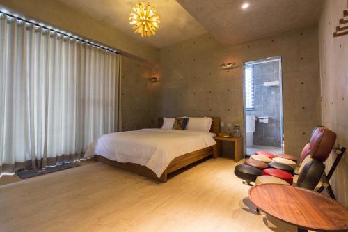 a bedroom with a bed and a table and chairs at Island Sunrise in Dongshan