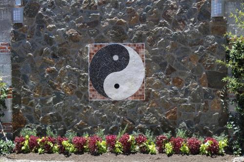 a stone wall with a painting of a bird on it at Hotel Boutique La Herencia in Tequisquiapan