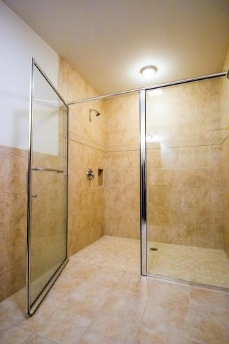 a shower with a glass door in a bathroom at Sutton Inn in Elkton