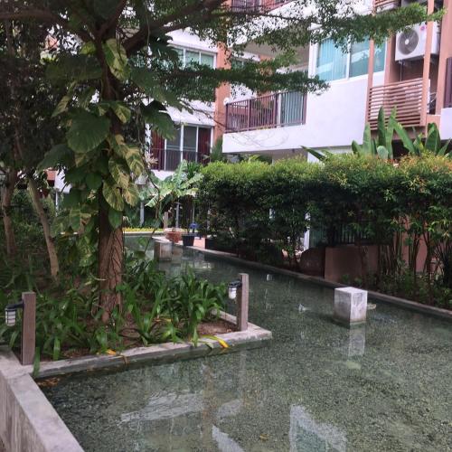 a pool of water in the middle of a building at Diamond Suite in Pattaya South