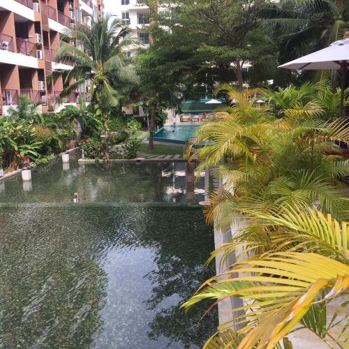 a swimming pool in the middle of a resort at Diamond Suite in Pattaya South