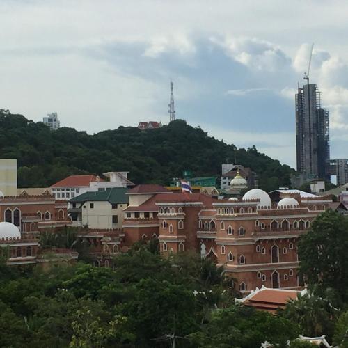 a group of buildings in a city with trees at Diamond Suite in Pattaya South