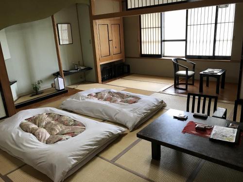 מיטה או מיטות בחדר ב-Kazen no Sho