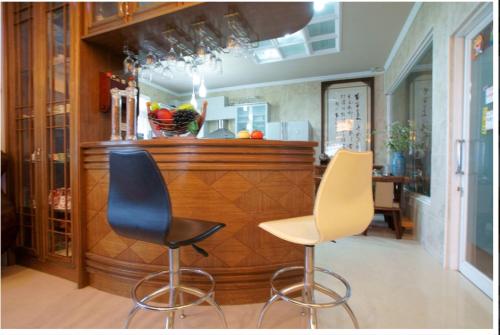 a bar with two chairs and a counter in a room at Emaly Homestay in Taitung City