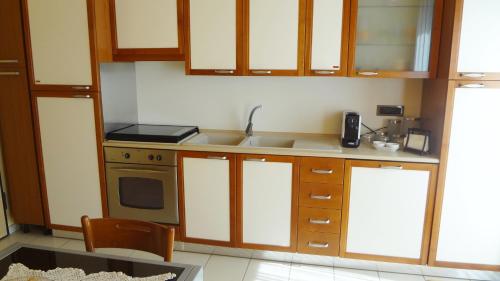 a kitchen with a sink and a stove at La trifula bianca apts. in Alba