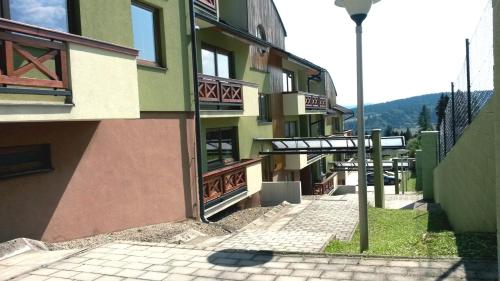 a side view of a building with a street light at Pine Wood Apartment in Vyšné Ružbachy