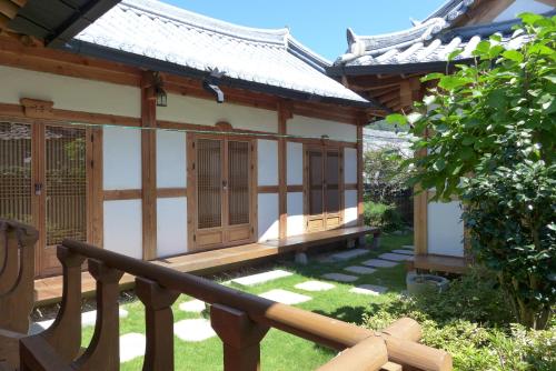 a small house with a wooden staircase leading to it at Sarangroo in Jeonju