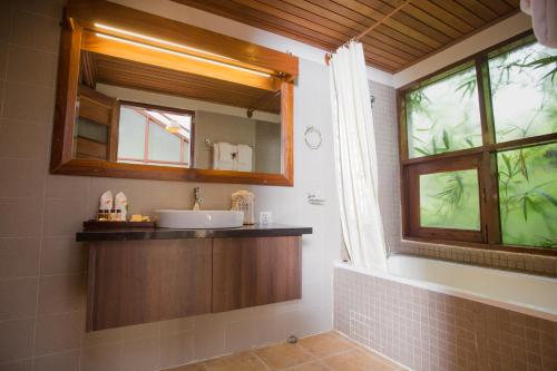 a bathroom with a sink and a mirror at Amata Resort & Spa, Ngapali Beach in Ngapali