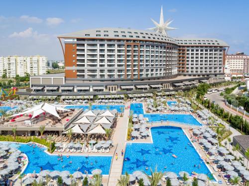 an aerial view of a resort with pools and umbrellas at Royal Seginus in Lara