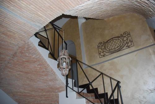 a staircase with a chandelier in a building at La Meridiana Relais in Formello