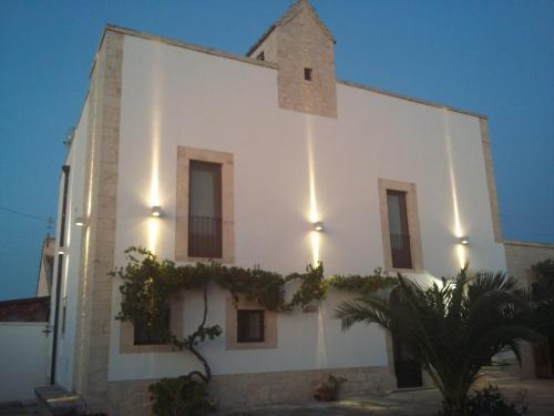 a white building with plants on the side of it at Masseria Nonna Angela in Putignano