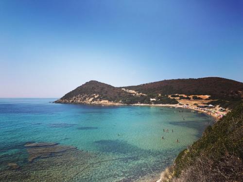 a view of a beach with people in the water at H24 Vacanze in Villanova Monteleone