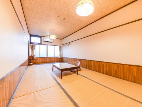 a bowling alley with a table in a room at Ryokan Marue Honkan in Hitoyoshi